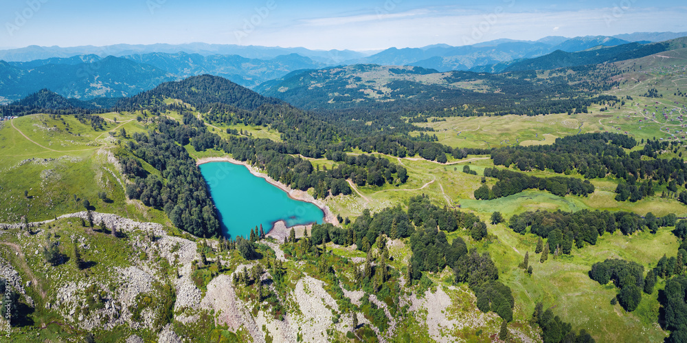 Aerial panorama of a turquoise lake in mountains, Mtsvane Lake, Georgia