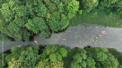 Fototapeta Naklejka Na Ścianę i Meble -  Natural river in the forest with peoples canoeing- aerial view