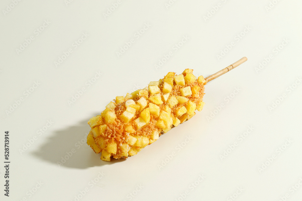 Delicious Crunchy Korean Style Chunky Potato Corn Dogs with Batter and Fried Potatoes. Isolated on Cream Background - obrazy, fototapety, plakaty 