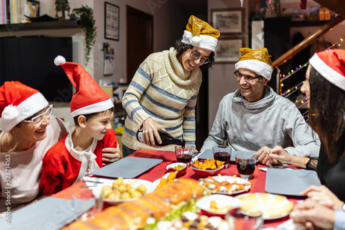 Happy family having fun at christmas dinner table - Celebration, holidays and xmas concept
