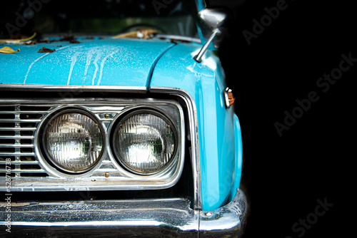Old blue classic car with headlight.