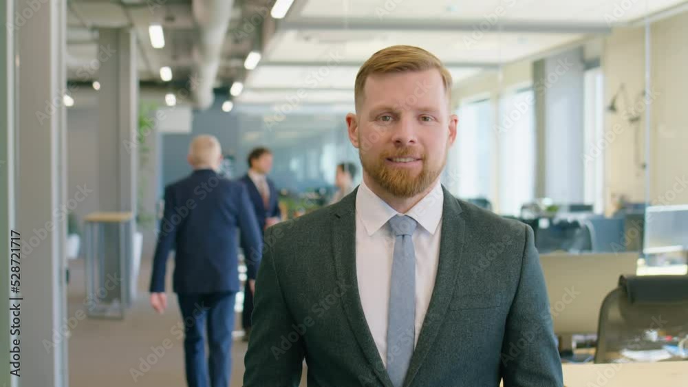 Waist up portrait shot of handsome businessman in formal suit posing for camera with smile during workday in office Waist up portrait shot of handsome businessman in formal suit posing for camera with smile during workday in office