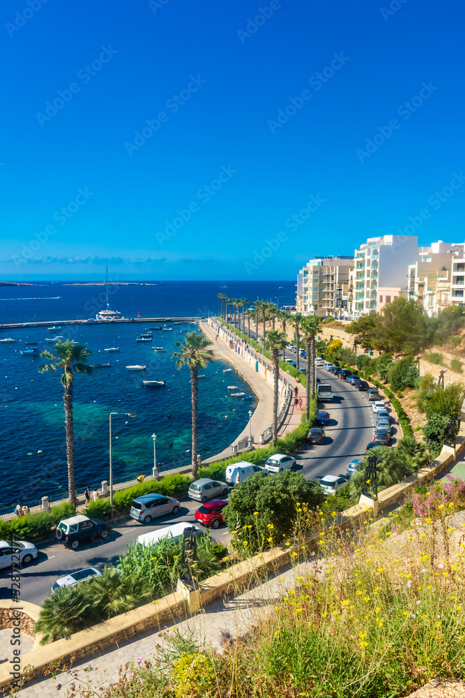 Naklejka premium Bugibba, Malta, 22 May 2022: View of the harbor and the promenade