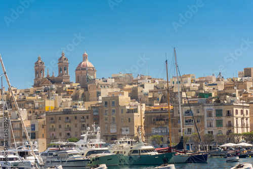 Fototapeta Naklejka Na Ścianę i Meble -  Birgu, Malta, 22 May 2022:  View of Cospicua, one of the three cities, from the marina of Birgu