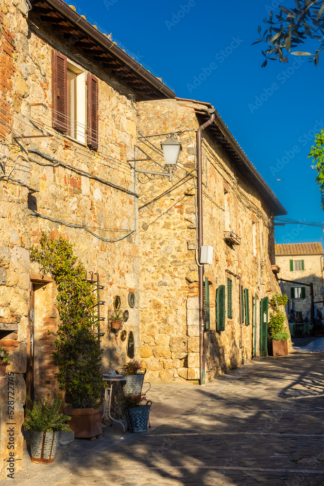 Monteriggioni,  Italy, 17 April 2022: historic center of the medieval town at sunset