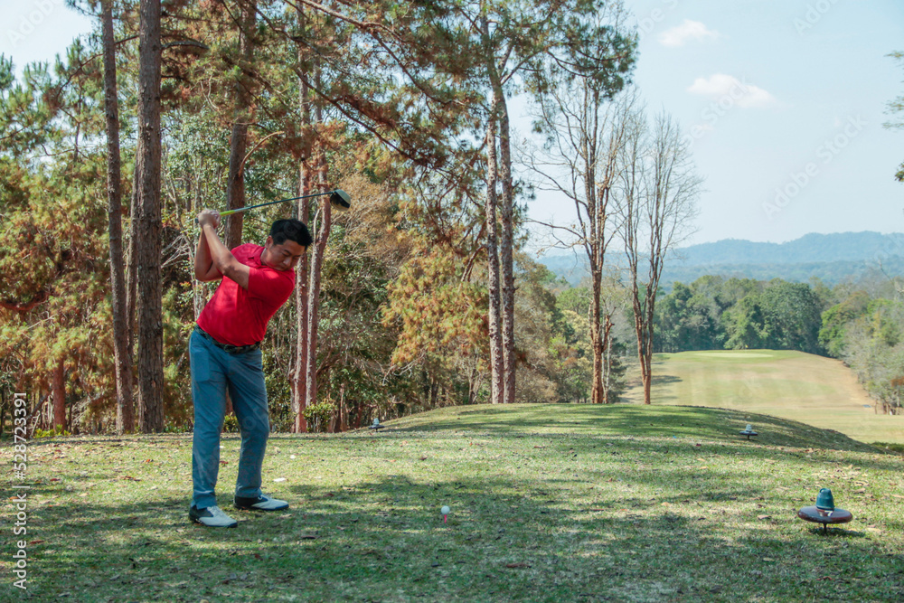 Golfer are playing game golf and hitting go on green grass mountain background. Asia male player game shot in summer.