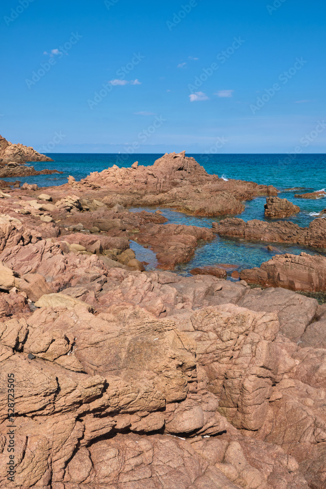 The little beach of Su Sirboni has red surfacing rocks - Sardinia - italy