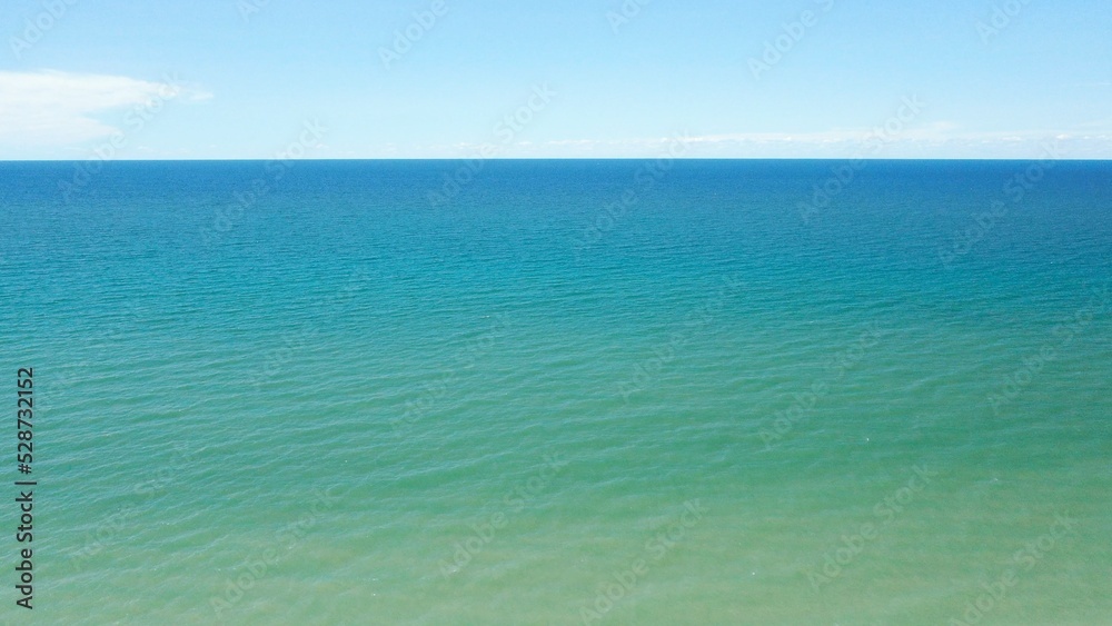 Peaceful blue water on Lake Ontario under blue sky Peaceful blue water on Lake Ontario under blue sky