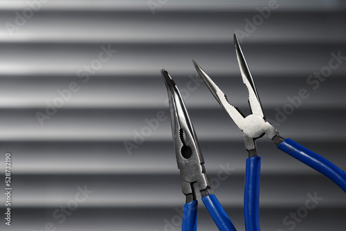 Billede på lærred Blue long nose pliers on gray background