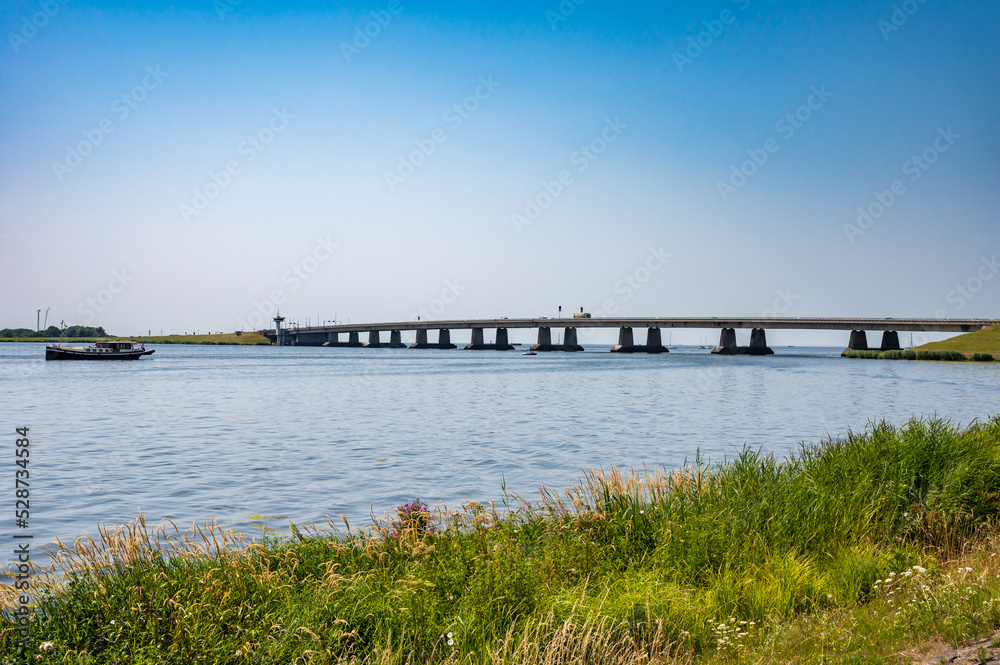 Nagele, Flevoland, The Netherlands - Bridge over the Ketel lake with the green polder and ships