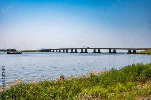 Nagele, Flevoland, The Netherlands - Bridge over the Ketel lake with the green polder and ships photo