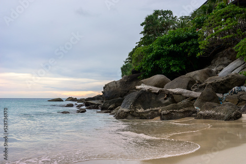 Scenery seascape with stones in water on sandy beach. Kata Noi, Phuket, Thailand