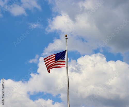 The united states flag blowing in the wind.