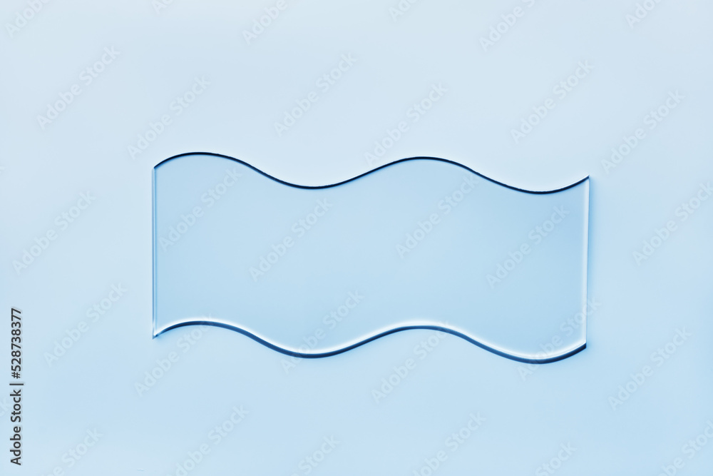 Empty glass wavy slide on blue background. Mockup for cosmetic or scientific product sample Empty glass wavy slide on blue background. Mockup for cosmetic or scientific product sample