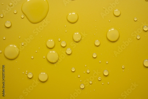 Drops of water on a yellow surface. Abstract background. Top view. 