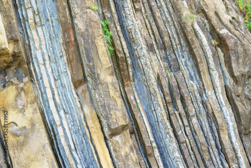 Different geological layers exposed that form a mountain on Mount Igeldo, San Sebastian, Spain photo