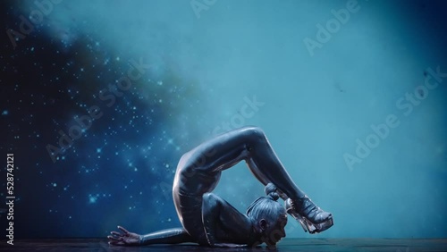 Flexible Woman Contortionist Performing on Stage Against Starry Space Back