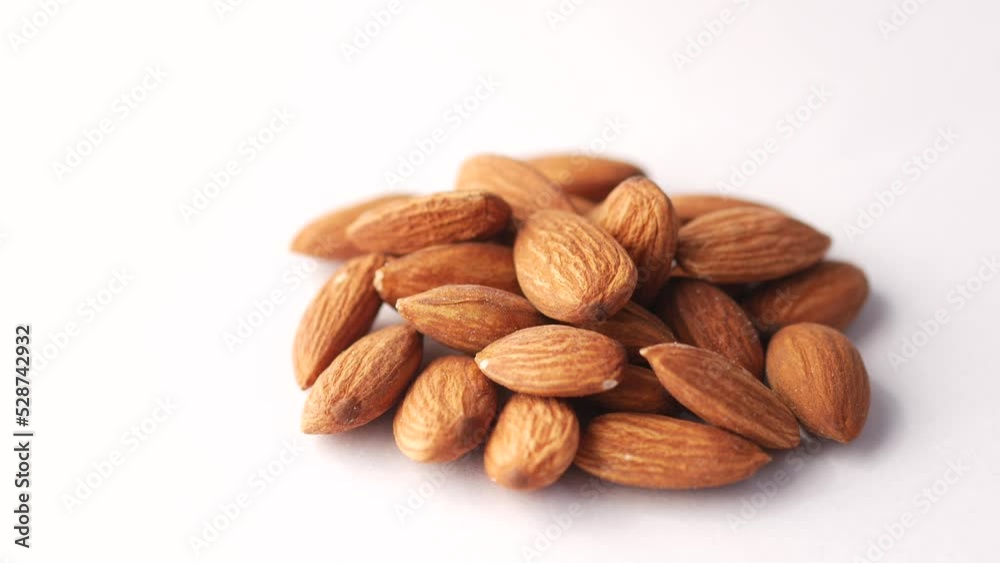 dark chocolate cream pouring on almond nut on white dark chocolate cream pouring on almond nut on white