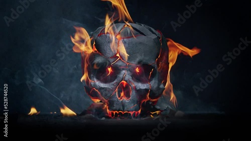 Burning skull. Slow motion fire flames and smoke.