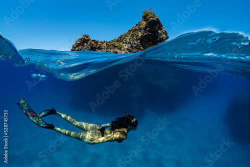 a girl dives in apnea in Mediterranean sea