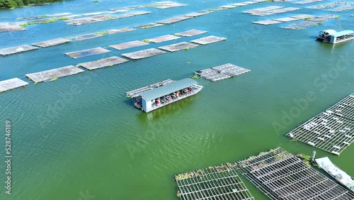 Fishing Boat with Large Catch Oysters Swirling Flock Gulls Aerial View Drone 4K in Oysters farm. Small Ship Floats on Sea Surface Blue Sky Leaving a Path of Sea Foam Water in Tainan, Taiwan Esat Asia photo