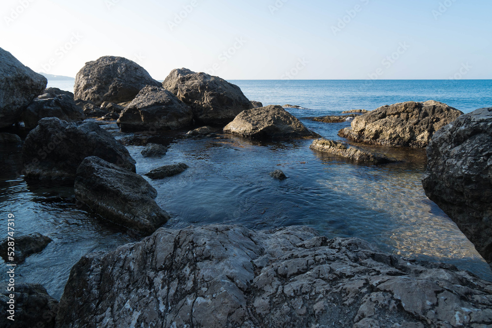 Rock formations on the background of the sea in the early morning. Clean water, ecosystem. The Crimean Laspi Reserve.