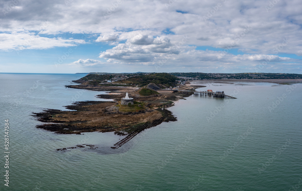 view of the Mumbles headland with the historic lighthouse and piers in Swansea Bay