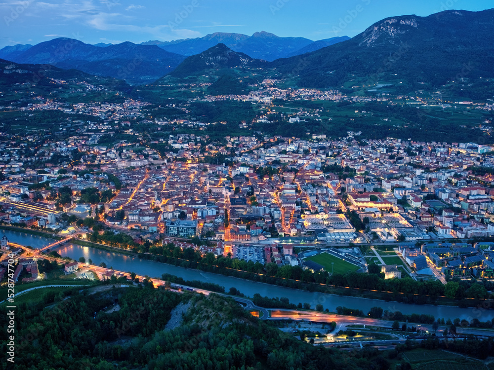 Trento city aerial panoramic view. Night city lights view from above in Trento city in Trentino Alto Adige in Italy.