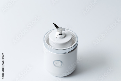 Close up of stainless steel blades of portable mini blender for making smoothie isolated on white background.