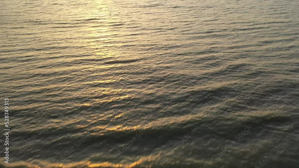 Ocean waves with early morning sun light reflecting on water in coastal South Carolina Ocean waves with early morning sun light reflecting on water in coastal South Carolina