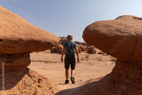 Young woman exploring the hoodoos at Goblin Valley State Park