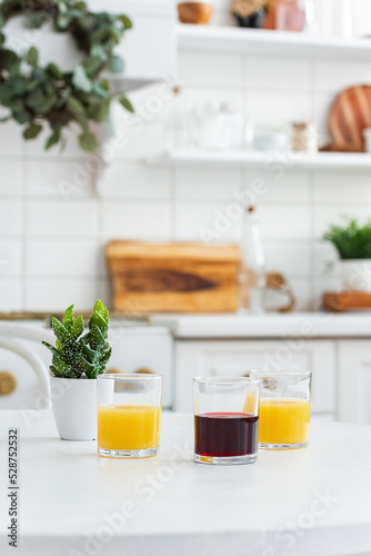fresh juice in glasses on the background of a bright kitchen