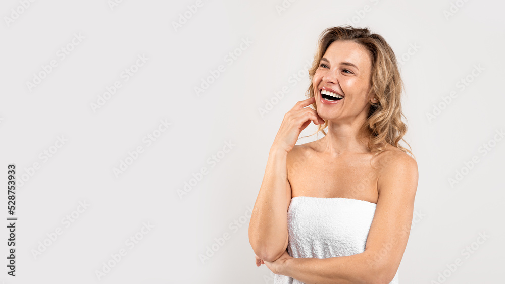 Body Care. Portrait Of Joyful Beautiful Middle Aged Woman Wrapped In Towel Body Care. Portrait Of Joyful Beautiful Middle Aged Woman Wrapped In Towel
