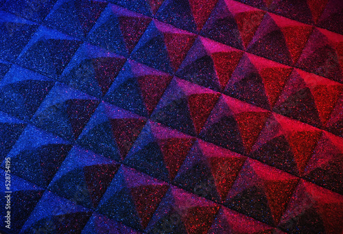 Pyramid sound isolation foam texture in a purple, artistic aesthetic. Material used in construction for sound proofing music recording, studios