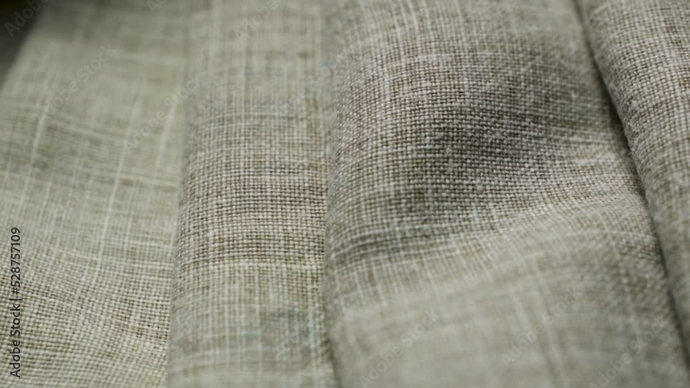 Folds on a natural linen texture background. Abstract thread pattern on a linen fabric