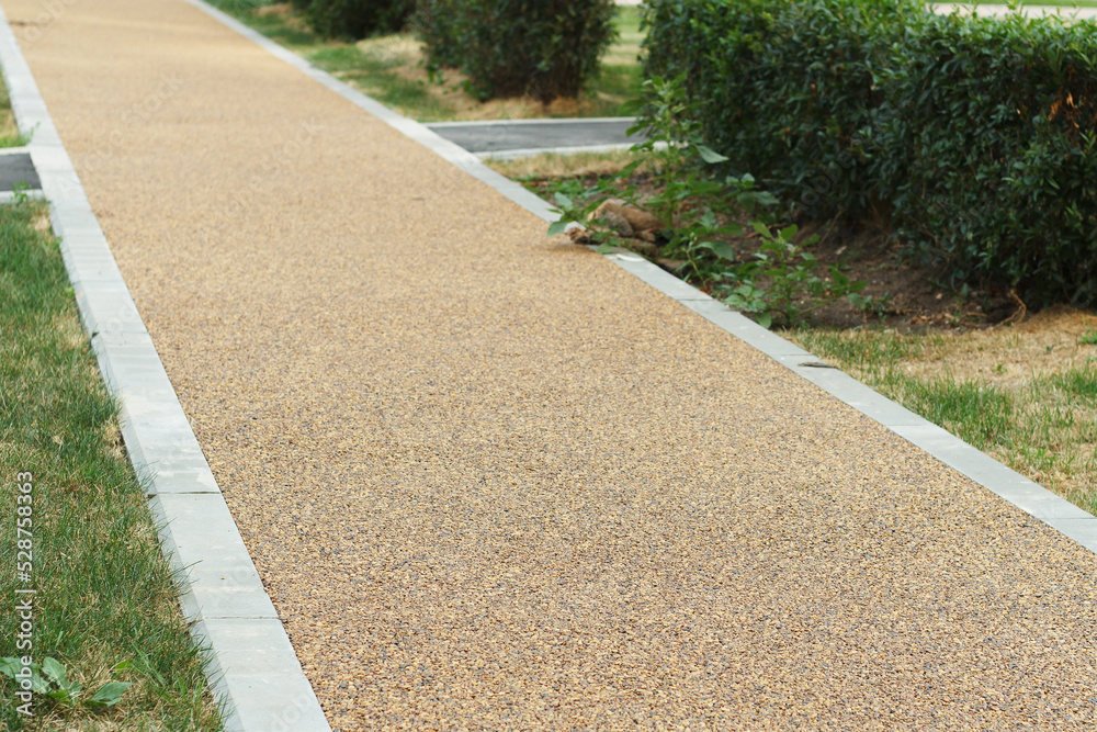 Obraz premium Small pebble road. Sidewalk pavement.