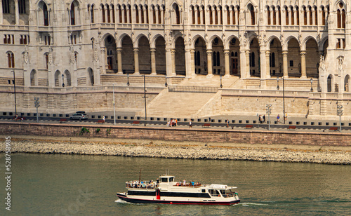 Photography Cruise ship sailing on the Danube in front of the Hungarian Parliament building in Budapest, Hungary