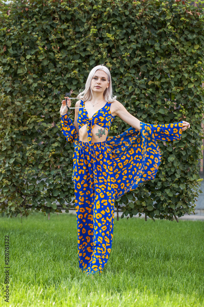 Young beautiful blonde woman in a stylish spotted summer suit Young beautiful blonde woman in a stylish spotted summer suit