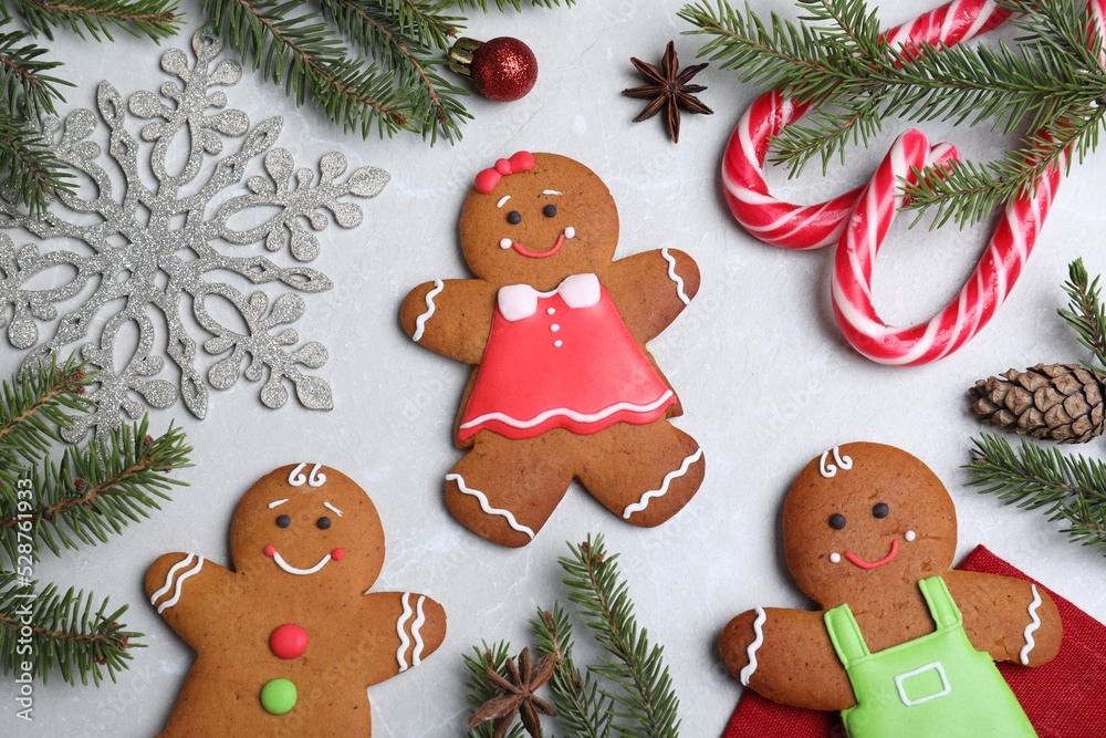 Flat lay composition with gingerbread people on light grey marble table Flat lay composition with gingerbread people on light grey marble table