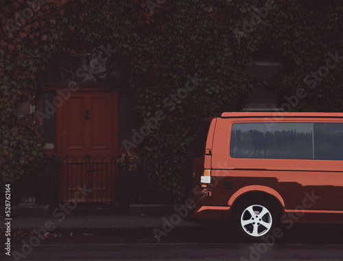 Red minivan parks in front of a house with a red door, ilustration