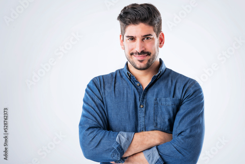 Smiling and handsome man wearing casual clothes while standing at isolated background