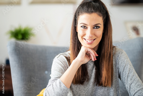 Smiling woman portrait while relaxing at home