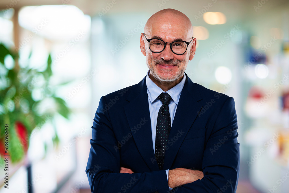 Fototapeta premium Middle aged businessman standing at the office