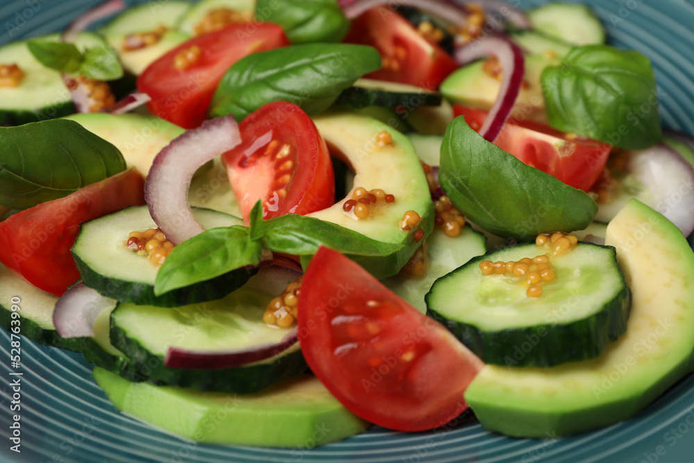Tasty salad with cucumbers on blue plate, closeup Tasty salad with cucumbers on blue plate, closeup