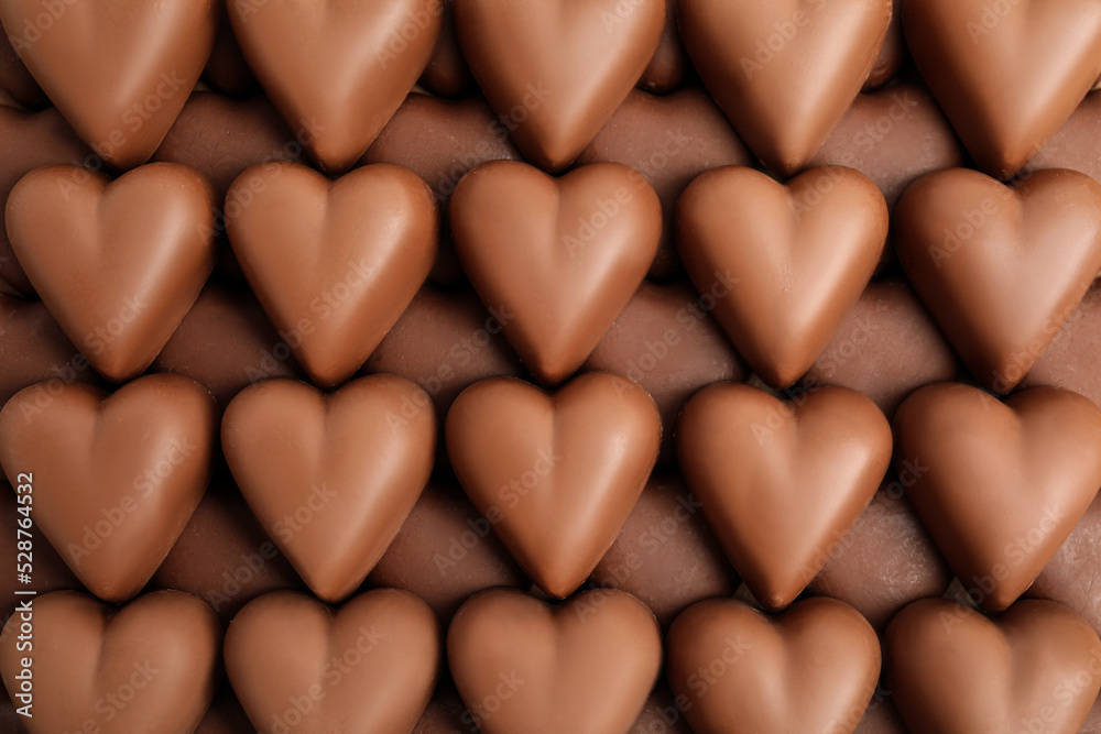Tasty heart shaped chocolate candies as background, top view. Valentine's day celebration Tasty heart shaped chocolate candies as background, top view. Valentine's day celebration