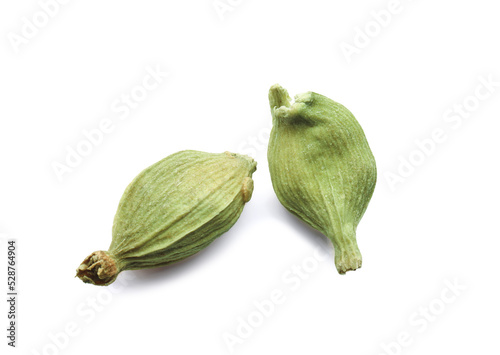 Dry green cardamom pods on white background, closeup