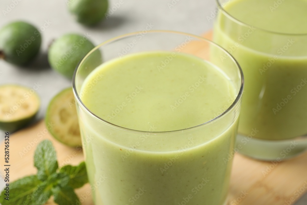 Fresh feijoa smoothie in glass on table, closeup view Fresh feijoa smoothie in glass on table, closeup view