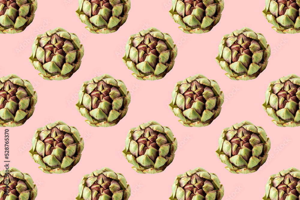 Fototapeta premium Fresh green artichokes on pink background. Seamless repeating pattern.