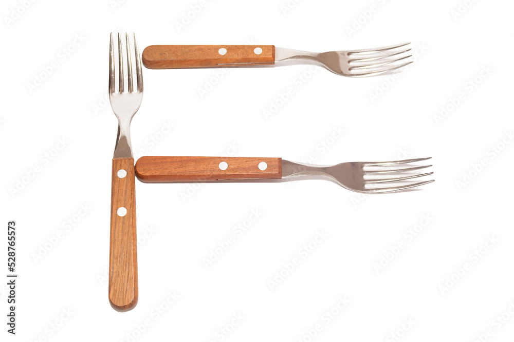 Naklejka premium 3 forks with wooden handles making the letter F on a white background