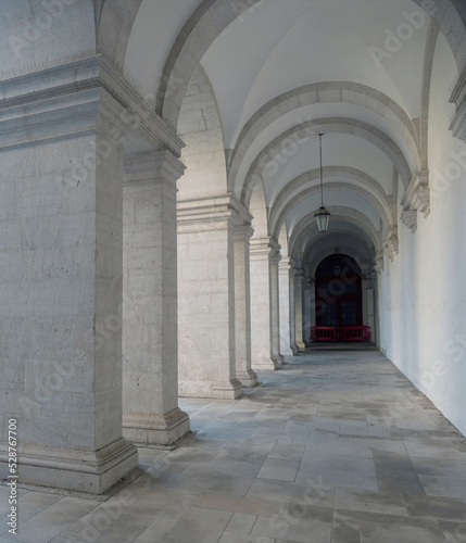 White archway colonnade in courtyard of Convento de Nossa Senhora da Graca  Lisbon  Portugal.